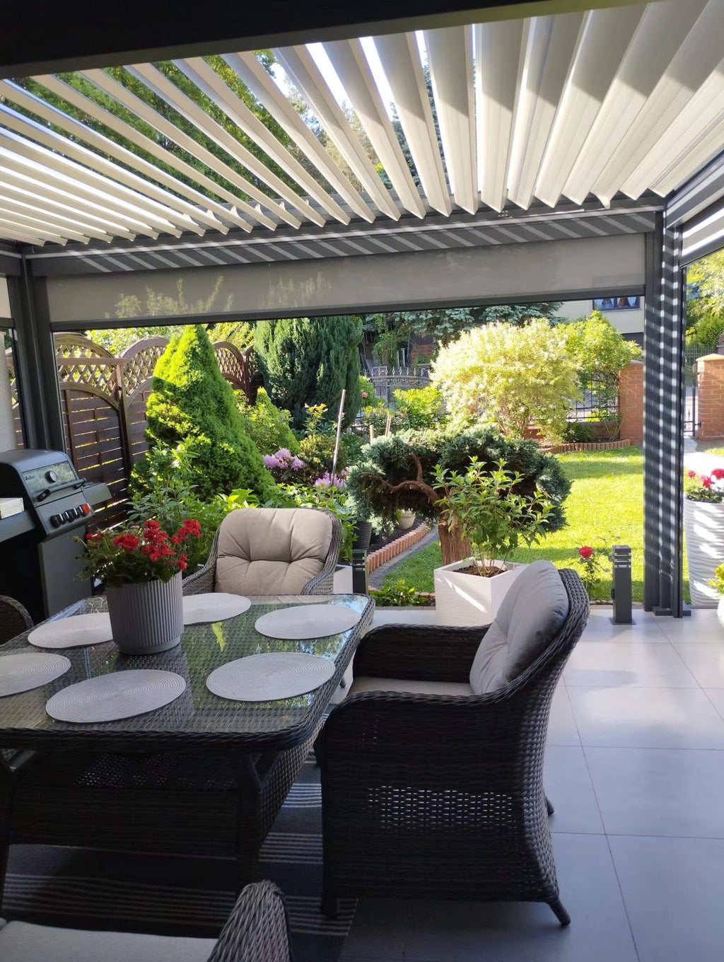 Louver pergola over an outdoor dining area, showing an optional privacy screen; furniture excluded