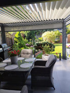 Louver pergola over an outdoor dining area, showing an optional privacy screen; furniture excluded